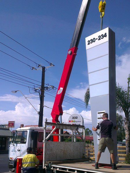 crane holding up sign