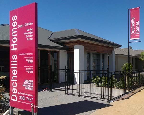 tall pink display home sign