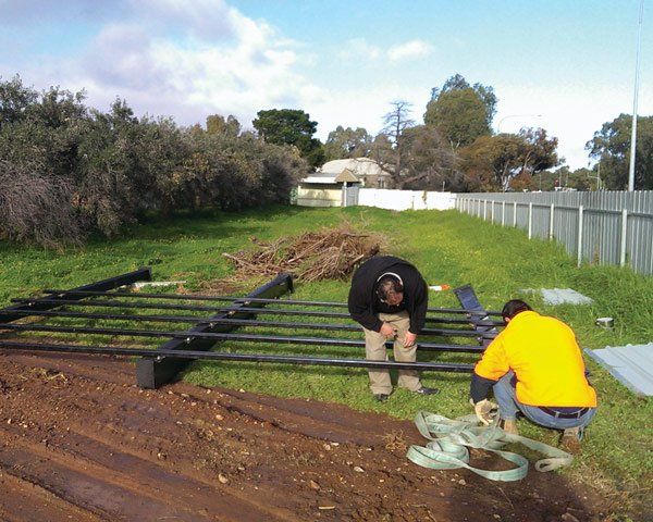 men building metal structure for sign