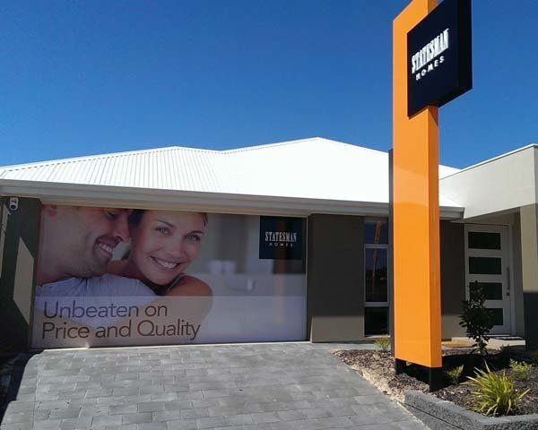 tall yellow display home sign